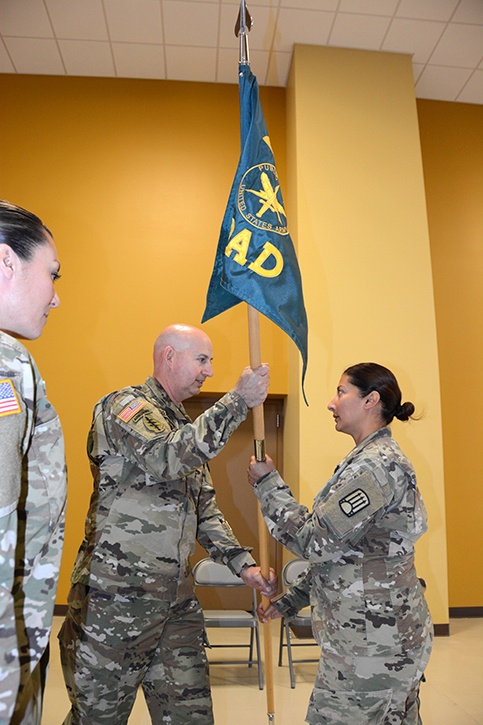 1st Lt. Maria Del Rio, incoming commander of the 200th Public Affairs Detachment, 93rd Troop Command, New Mexico Army National Guard, receives the unit's colors from the 93rd's commander.