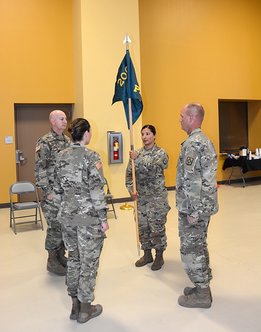 1st Lt. Maria Del Rio, new commander of the 200th Public Affairs Detachment, 93rd Troop Command, New Mexico Army National Guard, holds the unit's colors at attention during the PAD's change-of-command ceremony.