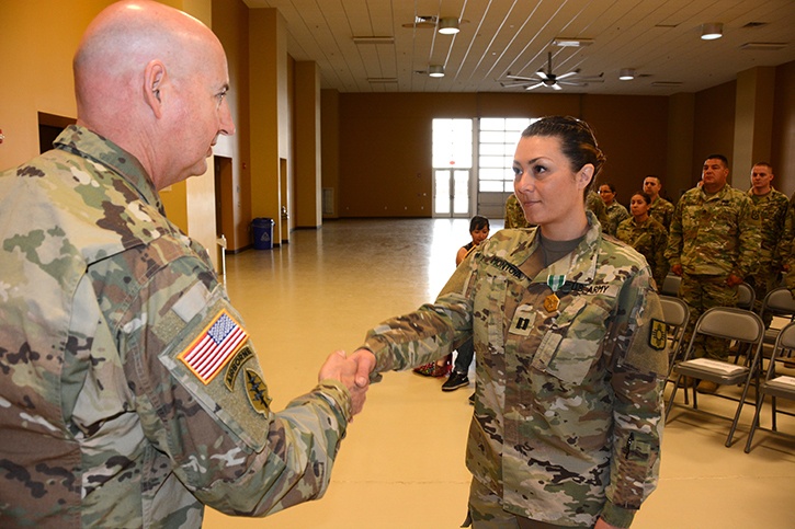 Capt. Erin Montoya, outgoing commander of the 200th Public Affairs Detachment, 93rd Troop Command, New Mexico Army National Guard, shakes hands with Col. Michael A. Treadwell, 93rd Troop Command commander.