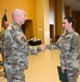 Capt. Erin Montoya, outgoing commander of the 200th Public Affairs Detachment, 93rd Troop Command, New Mexico Army National Guard, shakes hands with Col. Michael A. Treadwell, 93rd Troop Command commander.