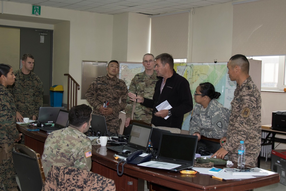 Pelle Rosdahl, peacekeeping subject matter expert, works with the multinational lower control operations center staff.