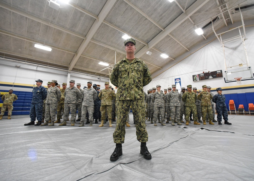 Service members stand in formation