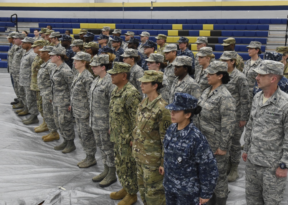 Service members stand in formation