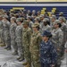 Service members stand in formation