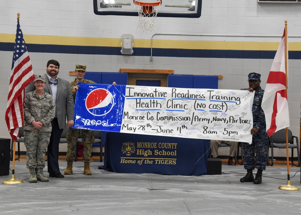 Service members present signed poster