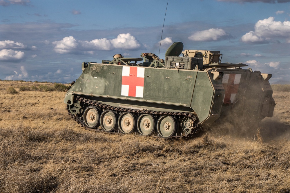 A medic M113 armored personnel carrier moves toward an objective