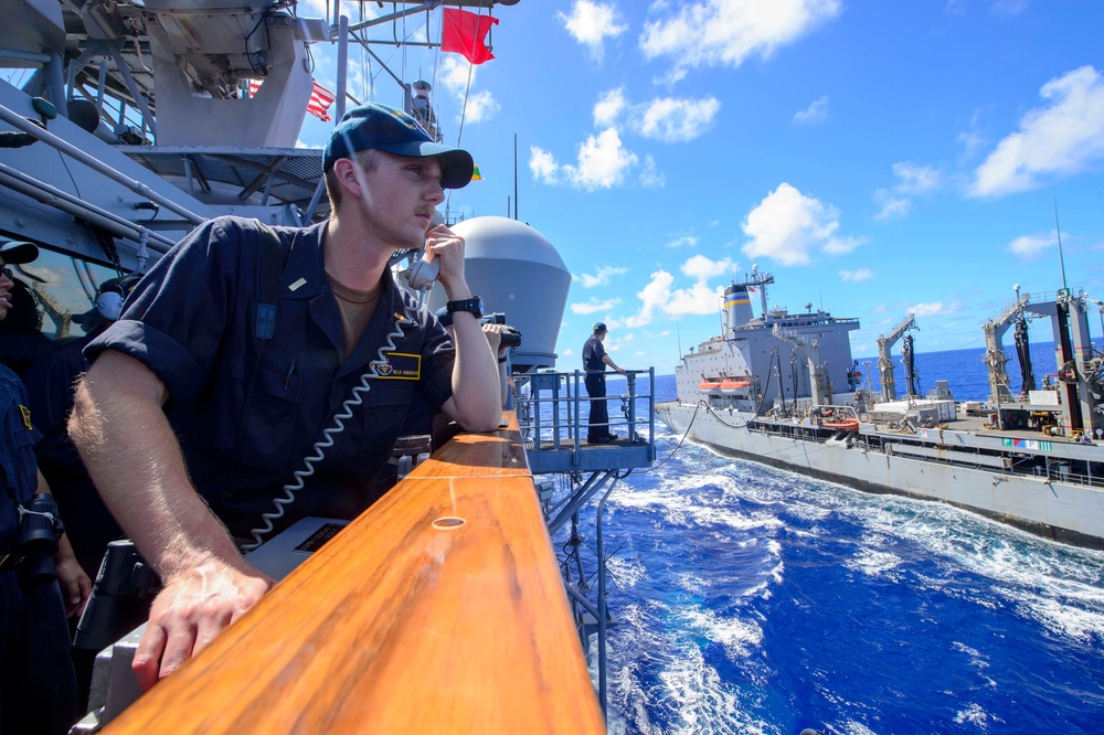 USS Antietam (CG 54) junior officer communicates with USNS Rappahannock (T-AO-204) during an underway replenishment