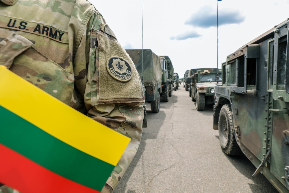 2CR Soldier stands with Lithuanian flag