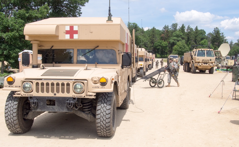Ambulances arrive as U.S. Army Reserve Soldiers with 865th Combat Support Hospital, based in Utica, N.Y., are offloading simulated, wounded Soldiers and performing triage as part of a mass casualty exercise.