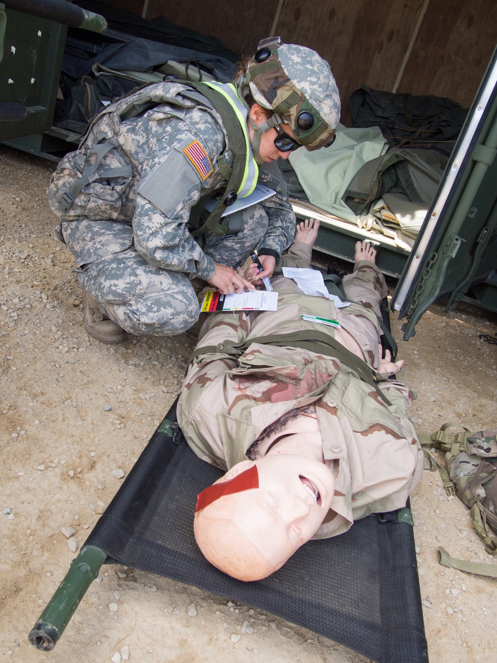 U.S. Army Reserve Soldiers with 865th Combat Support Hospital, based in Utica, N.Y., perform patient evaluations as part of a mass casualty exercise during Regional Medic CSTX 86-18-04.