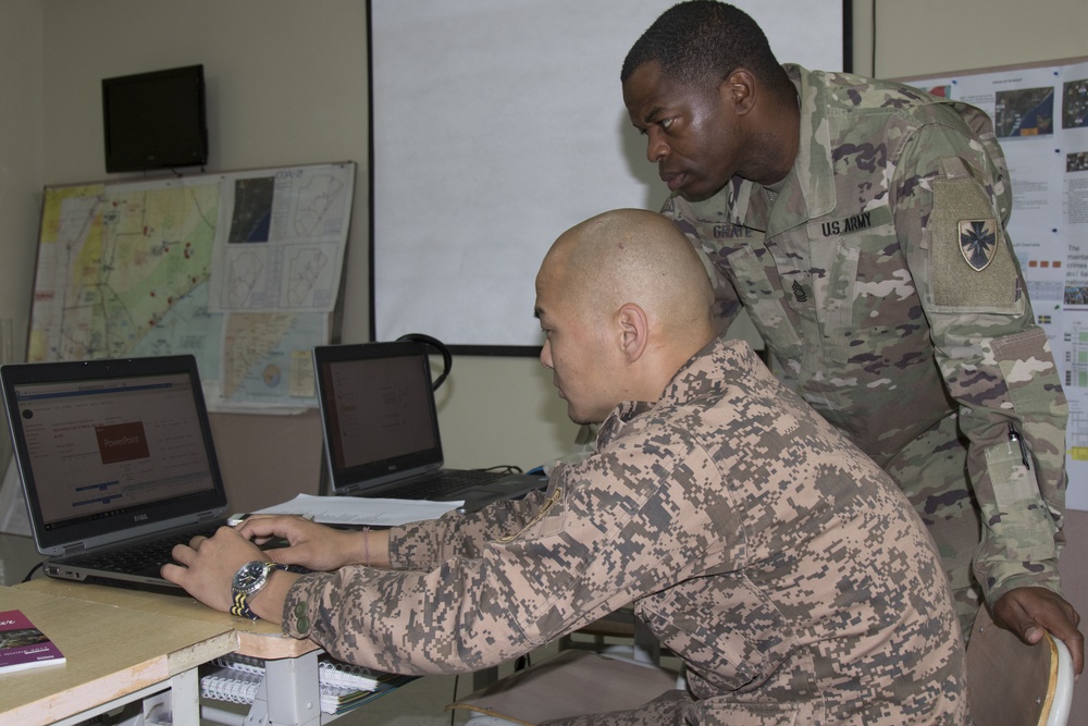U.S. Army Master Sgt. Anthony Grate, transportation supervisor, 8th Theater Sustainment Command works with Mongolian Armed Forces 1st Lt. Njamsmbuu Ganbat, language asset, June 23, 2018.