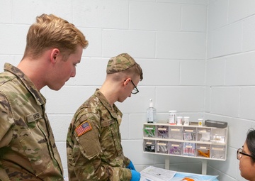 Pfc. Baker provides training to a fellow soldier