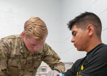 Pfc. Baker draws blood during the physical health assessment