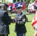 Command Sgt. Maj. Sergio Ortega receives the American flag