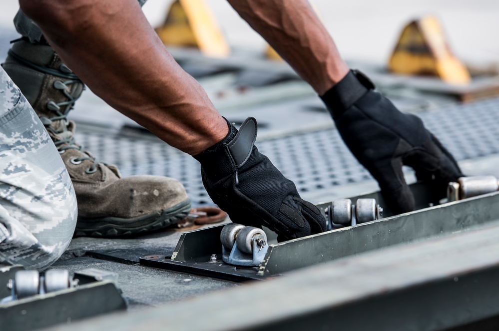 375th LRS Airmen unload C-17