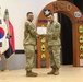 Honor graduate presents guest speaker with Certificate of Appreciation on behalf of graduates