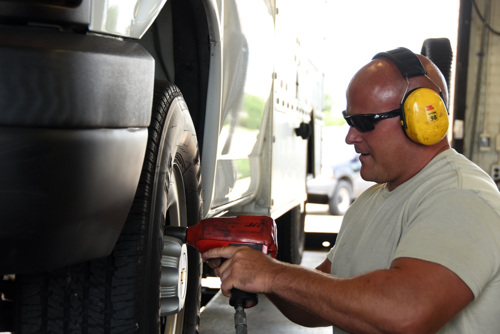 Heavy equipment mechanic changes a tire