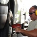 Heavy equipment mechanic changes a tire