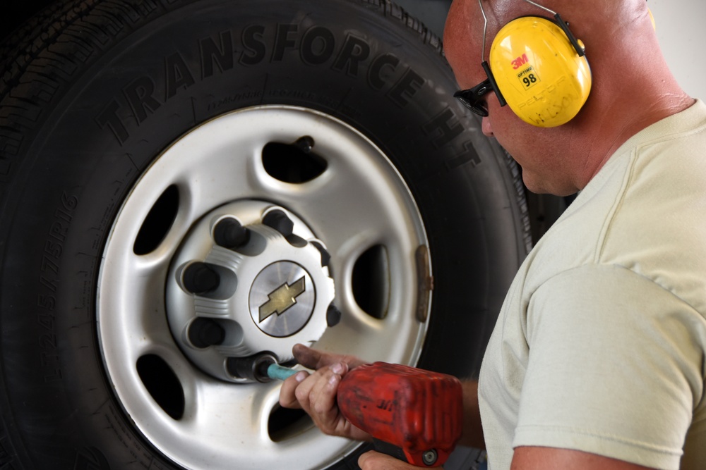 Heavy equipment mechanic changes a tire