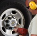 Heavy equipment mechanic changes a tire