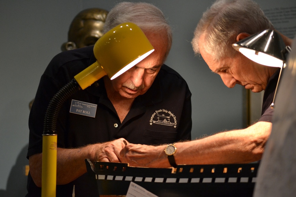 Model Ship Builders under the lamplight