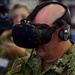 Vice Adm. John D. Alexander, commander, U.S. 3rd Fleet, participates in a demonstration of the Battlespace Exploitation Mixed Reality (BEMR Lab) GunnAR unified Gunner system with augmented reality during the RIMPAC 2018 Inaugural Innovation Fair