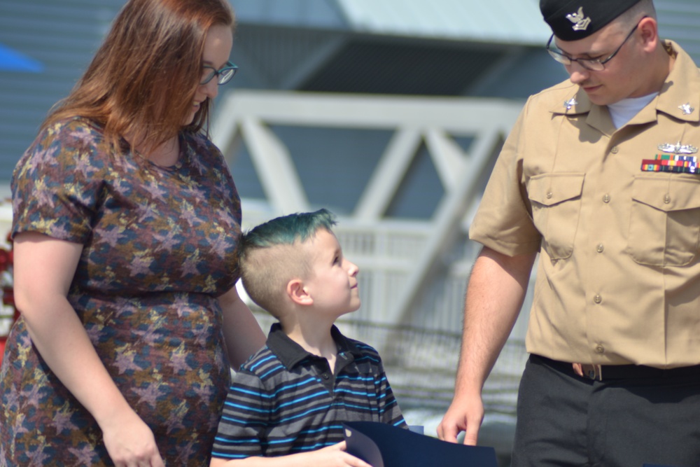 Family members receive certificates during re-enlistment