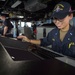 USS Antietam (CG 54) junior officer assists with navigation in the ship’s bridge