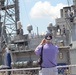 Visitors watch as USS Monterey docks next to the USS Wisconsin