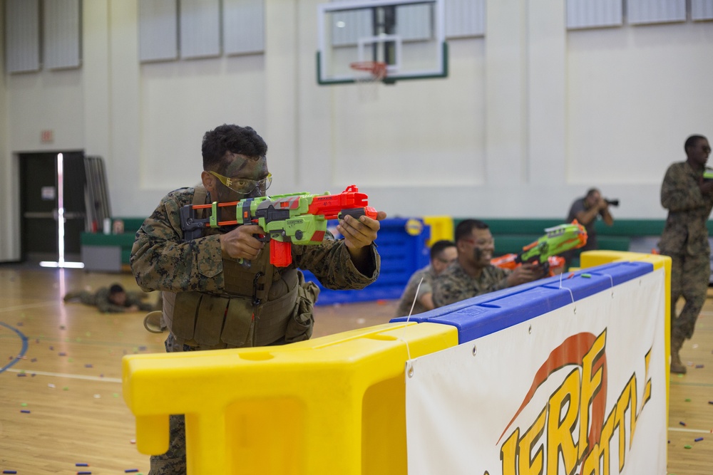 <em>A Marine defends his position with a Nerf gun before he is overrun by school children at NAS Sigonella (Colorized) (USMC)</em>