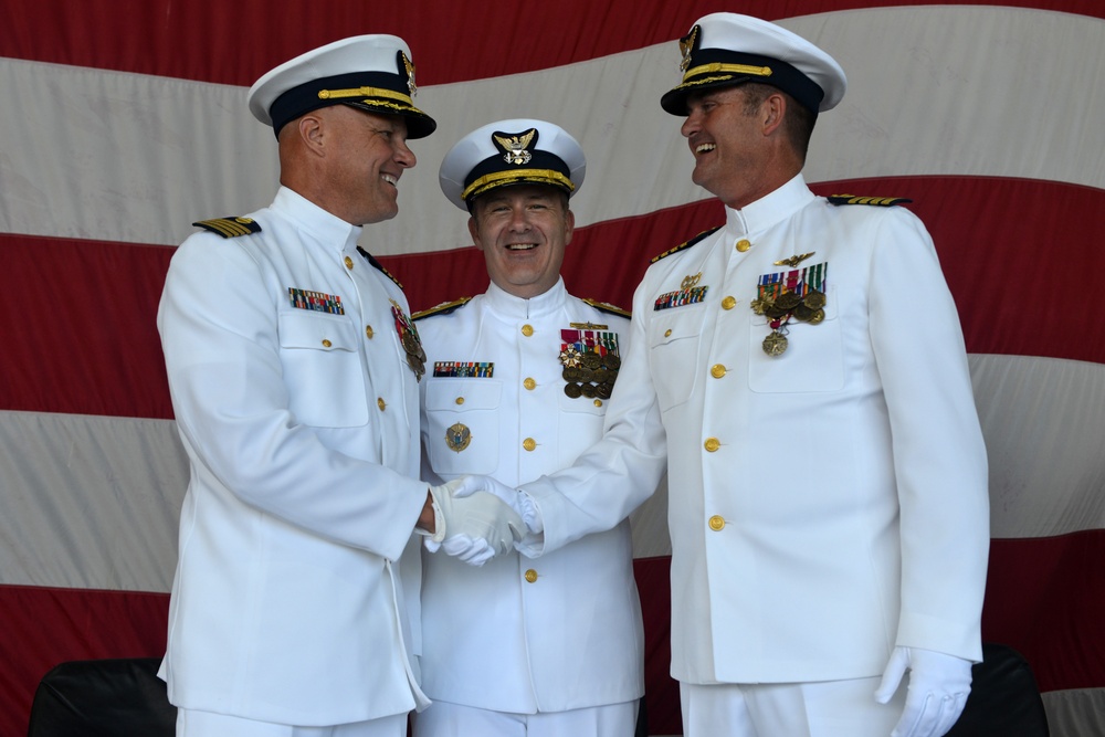 Two captains shake hands at a change of command ceremony