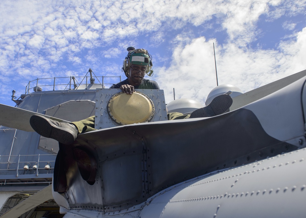 USS Antietam (CG 54) Sailor performs maintenance on an MH-60R Sea Hawk helicopter