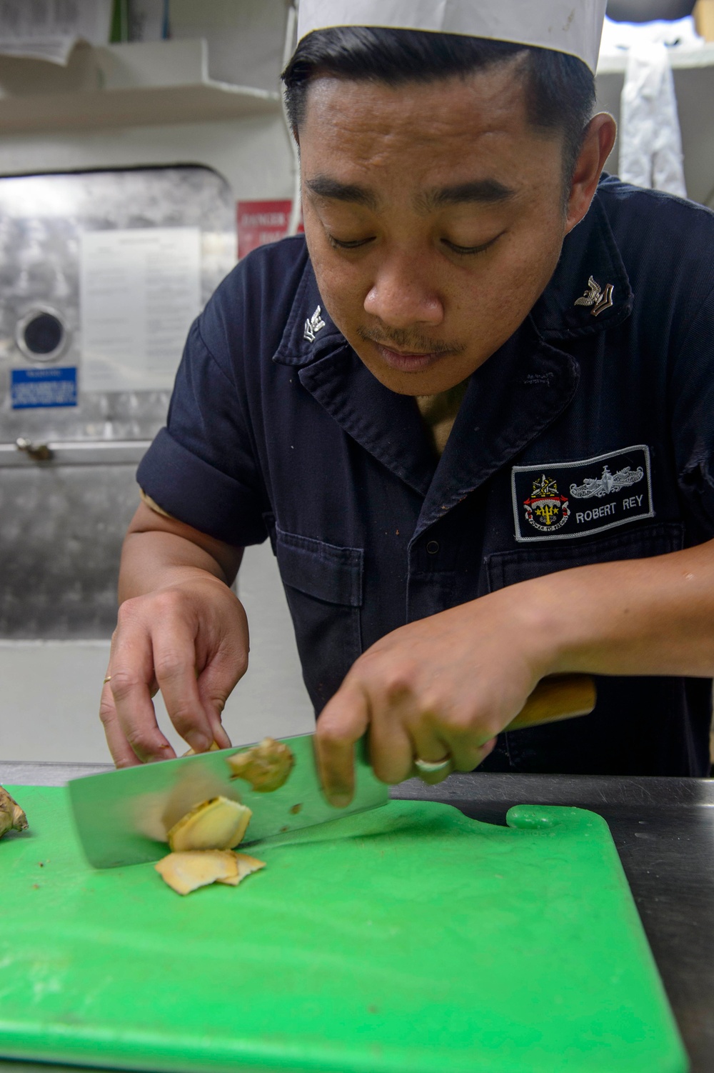 USS Antietam (CG 54) Sailor prepares food in the ship’s galley