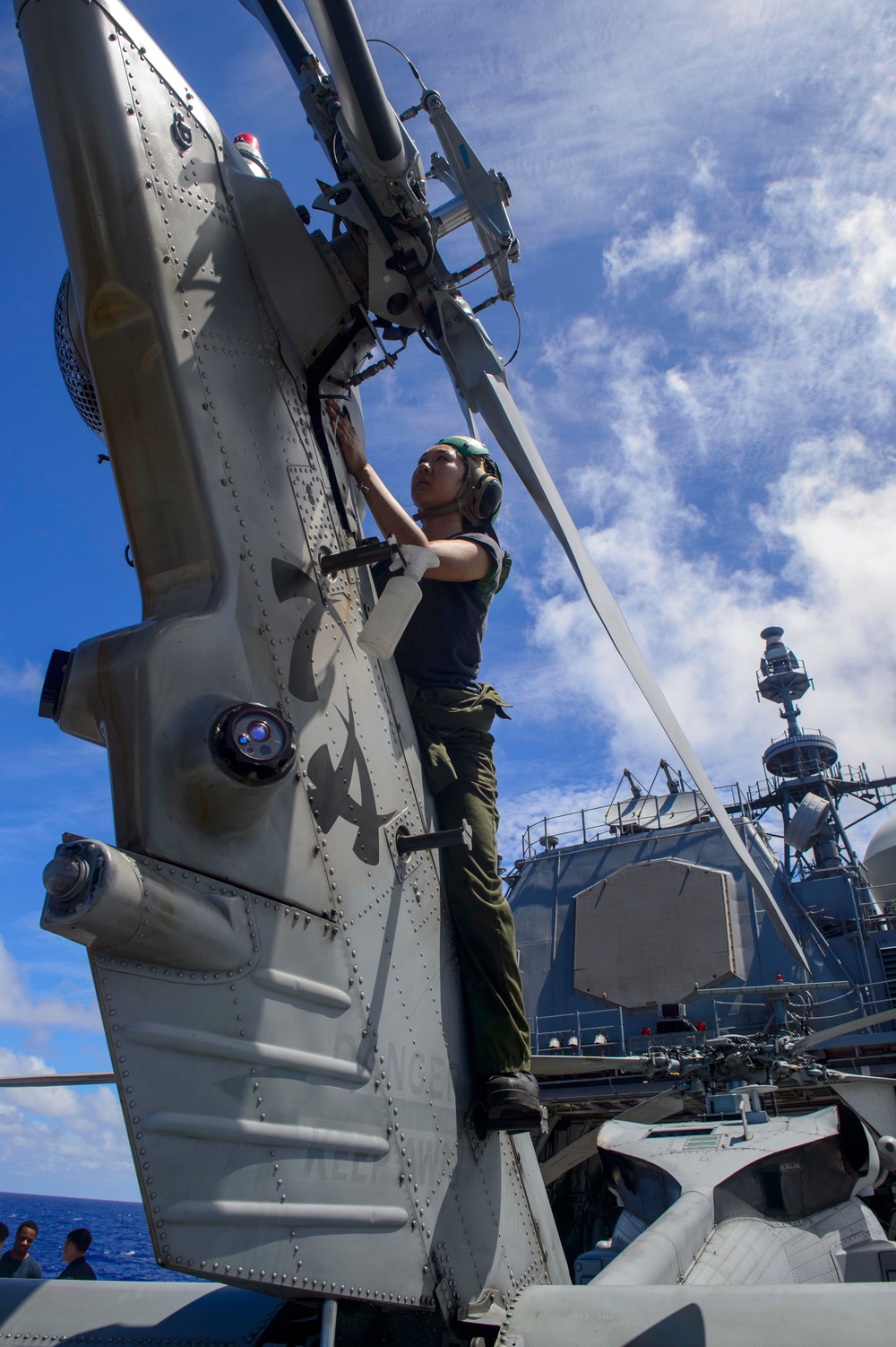 USS Antietam (CG 54) Sailor performs maintenance on a MH-60R Sea Hawk helicopter