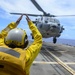 USS Antietam (CG 54) Sailor directs a helicopter on to the ship’s flight deck