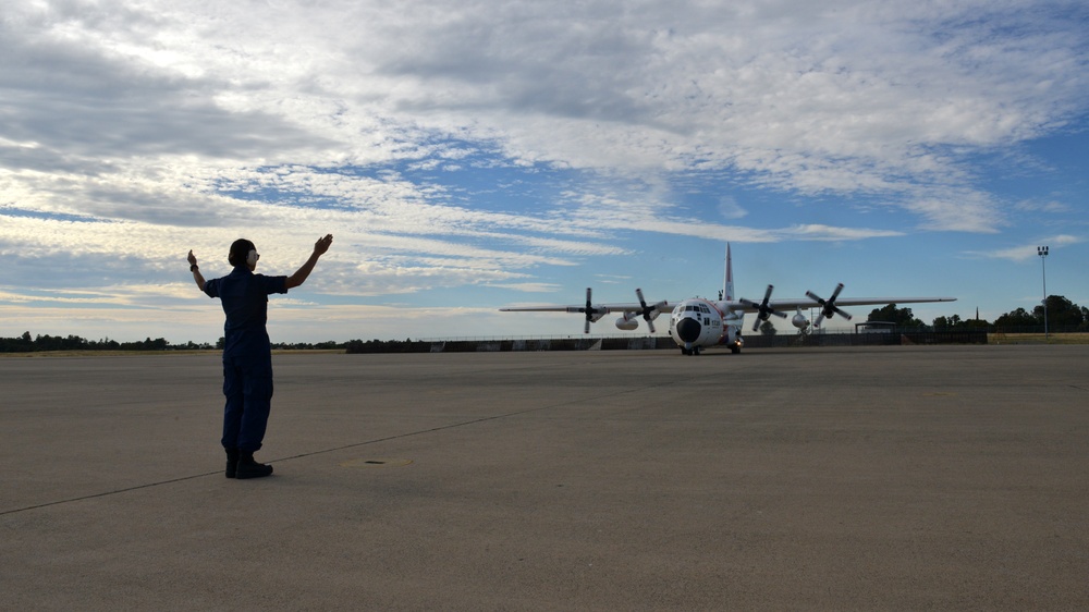 Coast Guard Pacific Strike team members and an Air Station Barbers point aircrew load decontamination gear for RIMPAC exercise