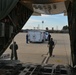 Coast Guard Pacific Strike team members and an Air Station Barbers point aircrew load decontamination gear for RIMPAC exercise