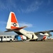 Coast Guard Pacific Strike team members and an Air Station Barbers point aircrew load decontamination gear for RIMPAC exercise