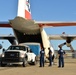 Coast Guard Pacific Strike team members and an Air Station Barbers point aircrew load decontamination gear for RIMPAC exercise