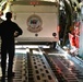 Coast Guard Pacific Strike team members and an Air Station Barbers point aircrew load decontamination gear for RIMPAC exercise