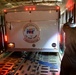 Coast Guard Pacific Strike team members and an Air Station Barbers point aircrew load decontamination gear for RIMPAC exercise