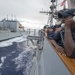 USS Antietam (CG 54) junior officer communicates with USNS Cesar Chavez (T-AKE-14) during an underway replenishment
