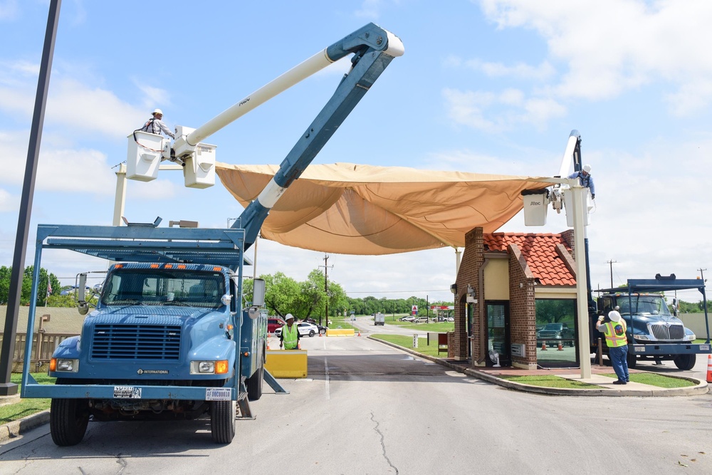 A 502nd Civil Engineer squadron high voltage team re-attaches the cover over Medina Base Gate
