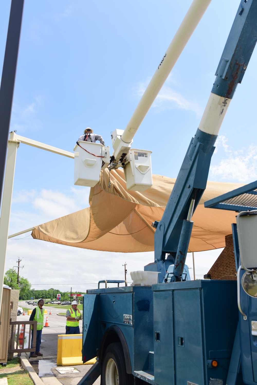 A 502nd Civil Engineer squadron high voltage team re-attaches the cover over Medina Base Gate