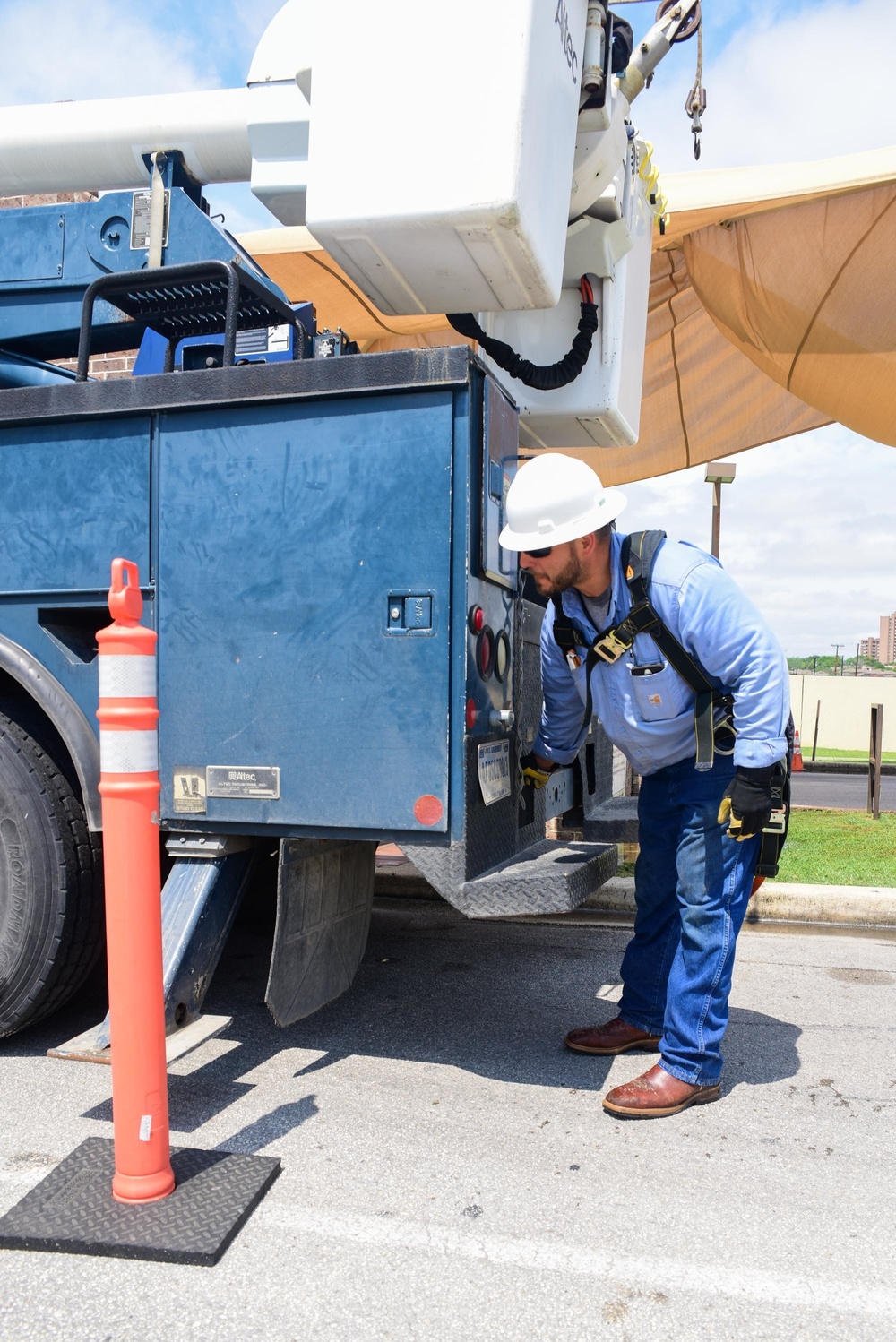 A 502nd Civil Engineer squadron high voltage team re-attaches the cover over Medina Base Gate