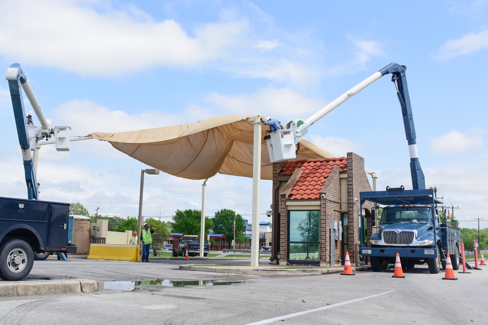 A 502nd Civil Engineer squadron high voltage team re-attaches the cover over Medina Base Gate
