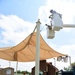 A 502nd Civil Engineer squadron high voltage team re-attaches the cover over Medina Base Gate