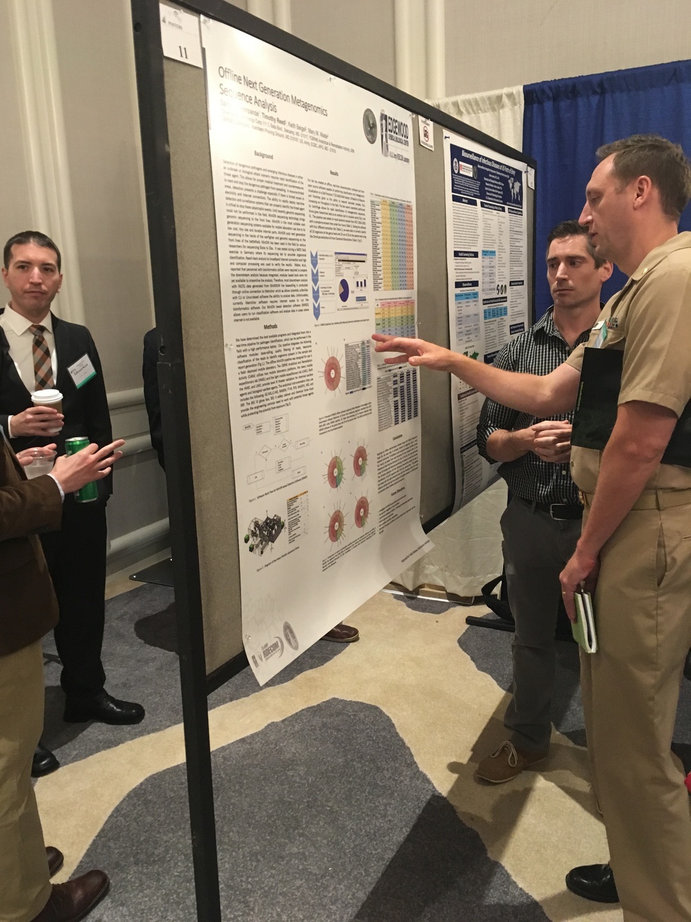 Reed explains poster at conference