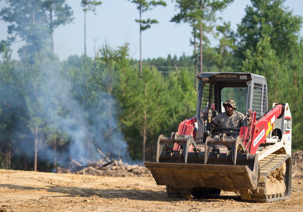 166th Civil Engineer Squadron members burn excess wood at Camp Kamassa.