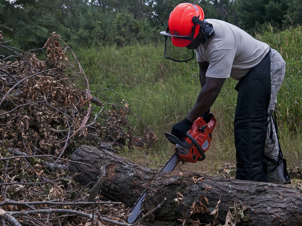 Civil Engineering Airmen clear debris from roadway during PATRIOT exercise